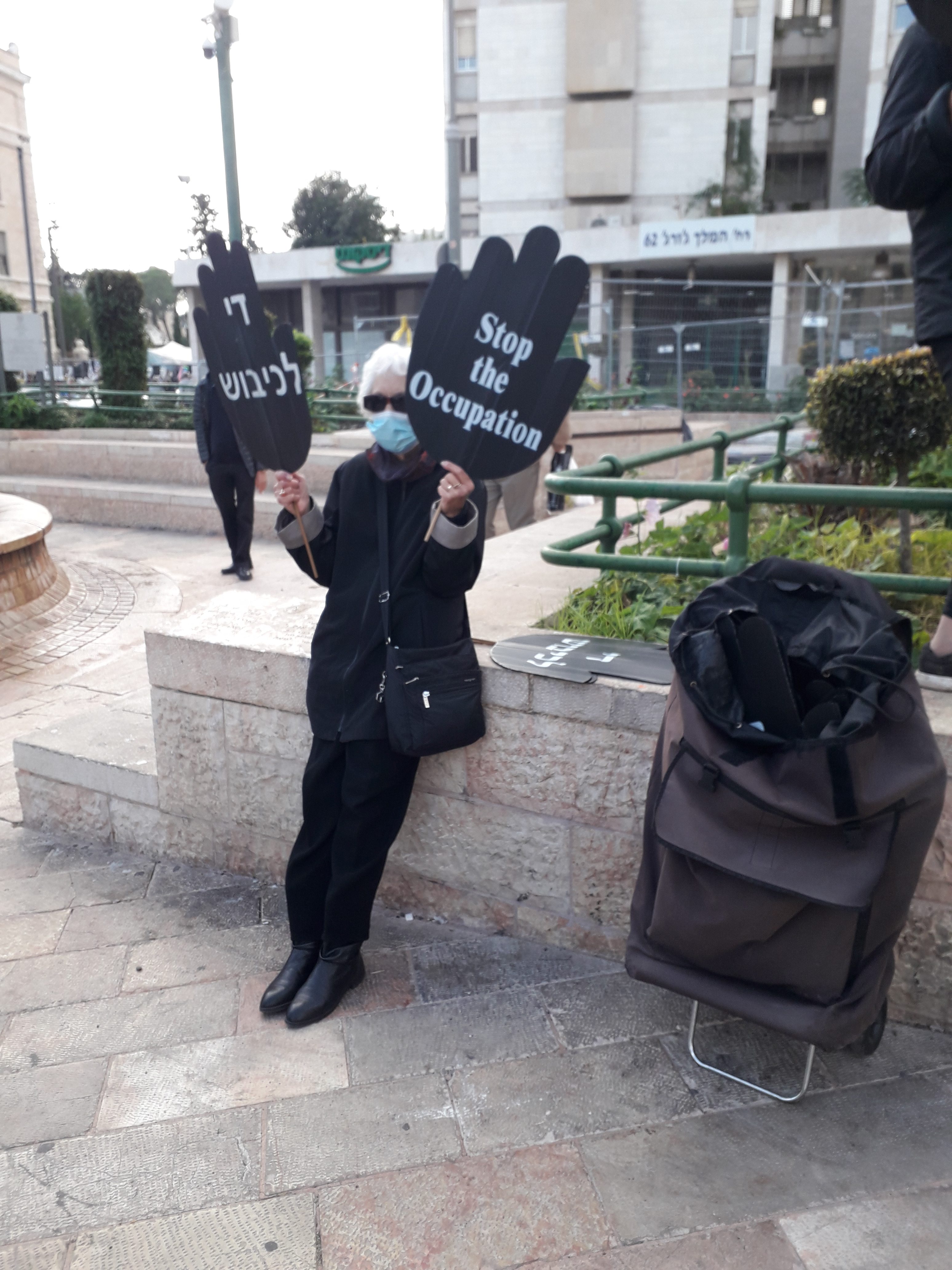 A woman in black protesting against the Israeli occupation of the west bank and Gaza strip